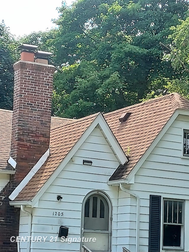 1205 Copeman Blvd, Flint, MI 48504 - exterior view of roof with shingles, gutters, and a downspout