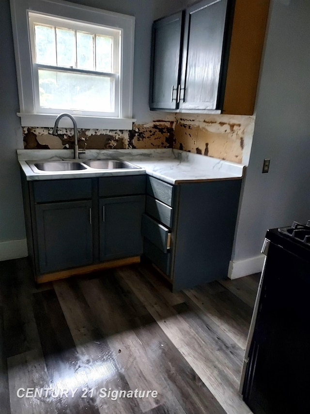 1205 Copeman Blvd, Flint, MI 48504 - kitchen with stove, wood finished floors, and light countertops