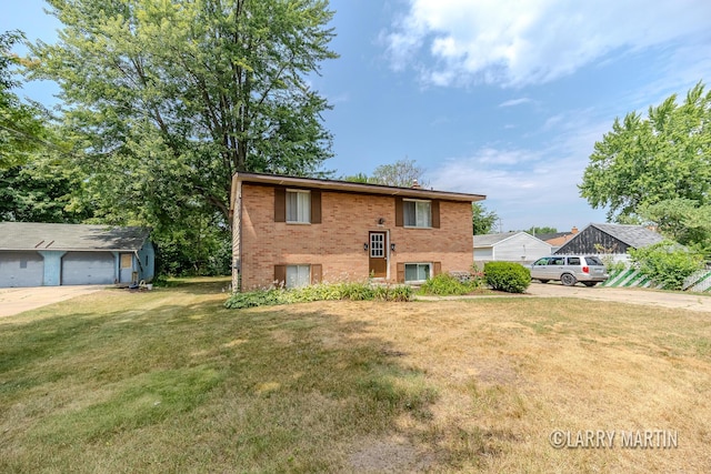 3607 Colby Ave SW, Wyoming, MI 49509 - view of front facade featuring brick siding, a front yard, and a garage