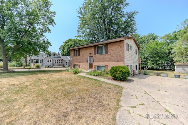 3607 Colby Ave SW, Wyoming, MI 49509 - split foyer home with brick siding, concrete driveway, a chimney, and a front yard
