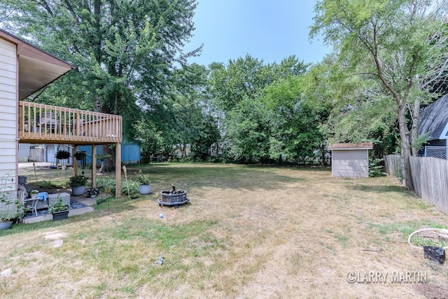 3607 Colby Ave SW, Wyoming, MI 49509 - view of yard with a storage unit, a fire pit, and a wooden deck