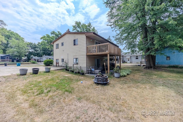3607 Colby Ave SW, Wyoming, MI 49509 - back of house with an outdoor fire pit, a yard, a wooden deck, and a chimney