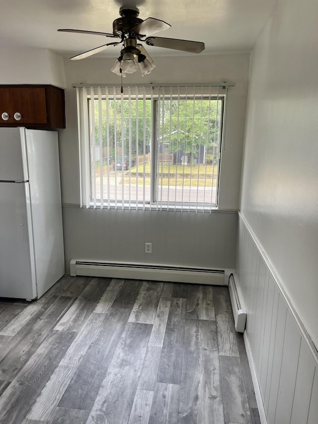 3607 Colby Ave SW, Wyoming, MI 49509 - unfurnished dining area with a ceiling fan, healthy amount of natural light, wainscoting, and wood finished floors