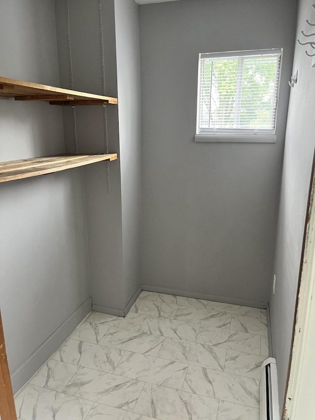 3607 Colby Ave SW, Wyoming, MI 49509 - unfurnished room with light marble finish flooring and a baseboard heating unit
