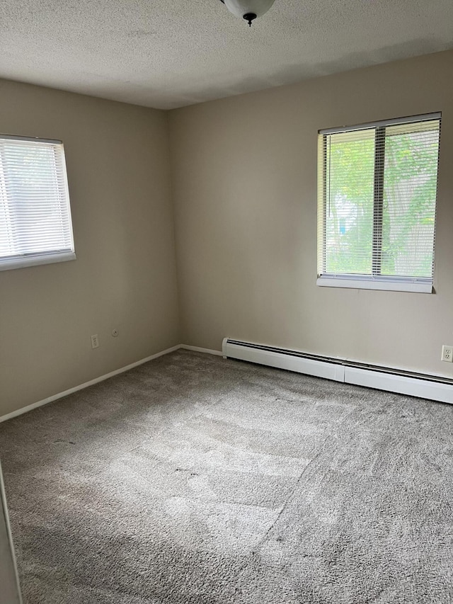 3607 Colby Ave SW, Wyoming, MI 49509 - carpeted spare room with baseboard heating and a textured ceiling