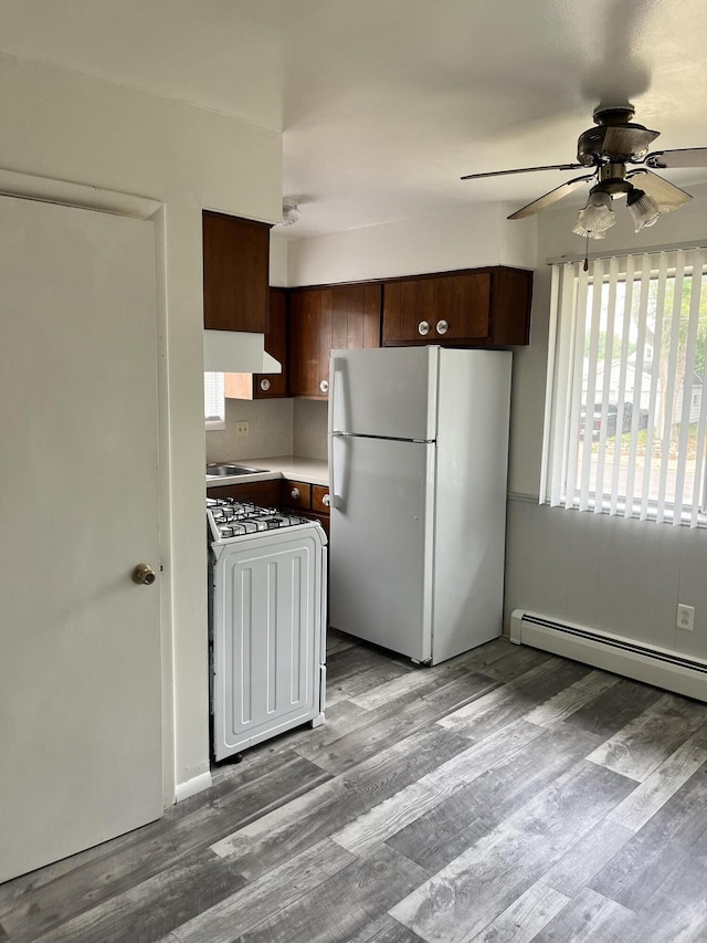 3607 Colby Ave SW, Wyoming, MI 49509 - kitchen featuring white appliances, a ceiling fan, wood finished floors, extractor fan, and dark brown cabinets