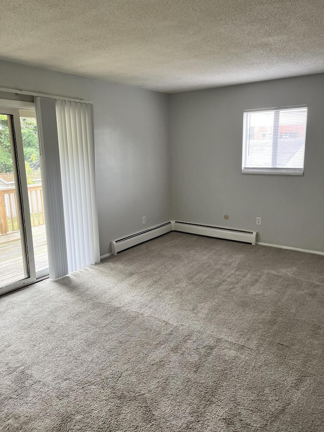 3607 Colby Ave SW, Wyoming, MI 49509 - spare room featuring healthy amount of natural light, carpet, a textured ceiling, and a baseboard radiator