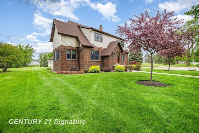 9610 Saginaw St, Reese, MI 48757 - view of front of property with a chimney, brick siding, and a front yard