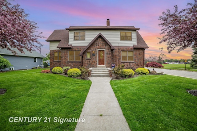 9610 Saginaw St, Reese, MI 48757 - view of front of house featuring a chimney, a front lawn, and brick siding