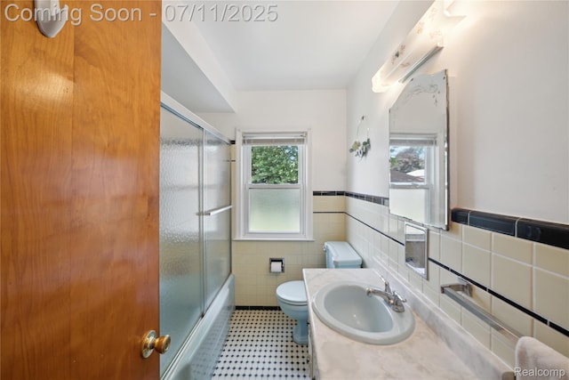 19190 Woodworth, Redford, MI 48240 - bathroom featuring tile walls, enclosed tub / shower combo, a wainscoted wall, and vanity