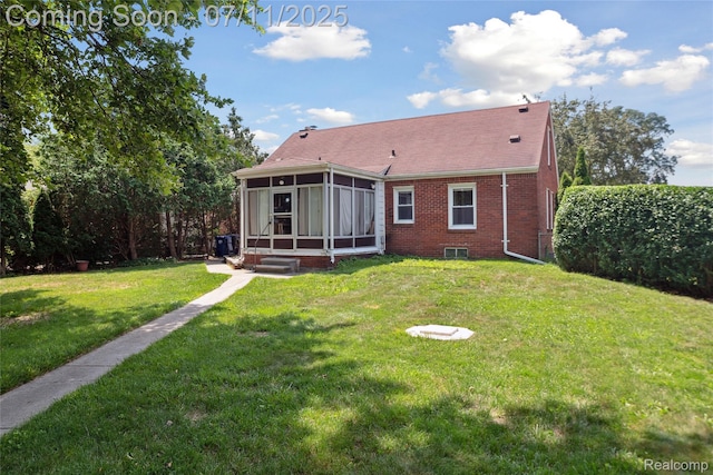 19190 Woodworth, Redford, MI 48240 - rear view of house with a sunroom, a lawn, and brick siding