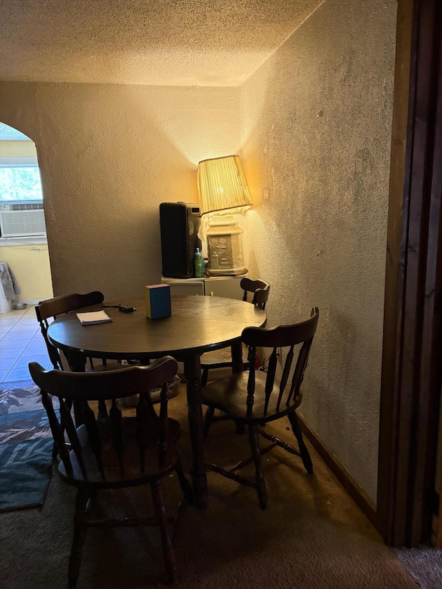 1993 Taube Ave, Benton Harbor, MI 49022 - carpeted dining area with a textured wall, arched walkways, cooling unit, and a textured ceiling