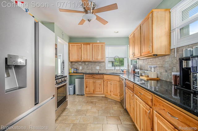 1510 S Harris Rd, Ypsilanti, MI 48198 - kitchen featuring stainless steel appliances, tasteful backsplash, a ceiling fan, light stone finish floors, and dark stone countertops