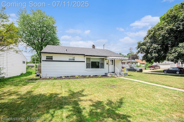 1510 S Harris Rd, Ypsilanti, MI 48198 - view of front facade with a front yard, a chimney, and roof with shingles