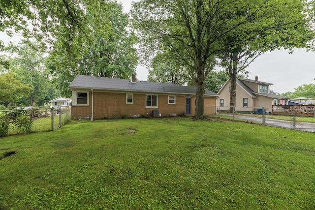 3026 Leigh Ave, Kalamazoo, MI 49048 - rear view of property featuring a gate, brick siding, and a fenced backyard