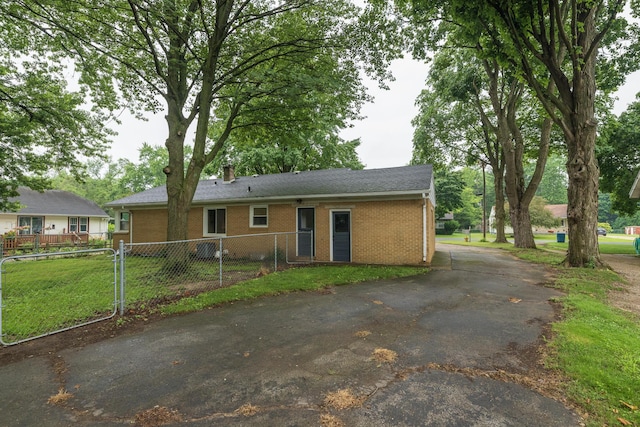 3026 Leigh Ave, Kalamazoo, MI 49048 - view of front of house with brick siding, a chimney, and driveway