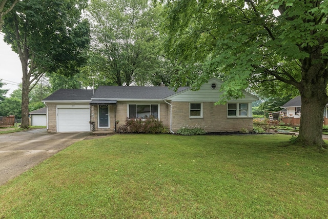3026 Leigh Ave, Kalamazoo, MI 49048 - ranch-style home featuring concrete driveway, a garage, and a front lawn