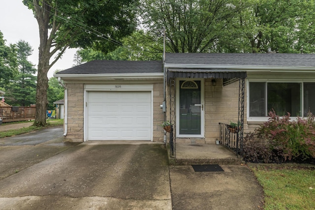 3026 Leigh Ave, Kalamazoo, MI 49048 - view of front of property with driveway, roof with shingles, and a garage