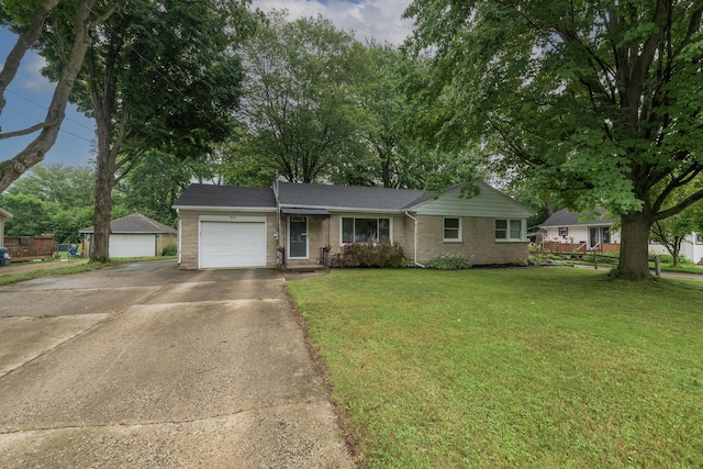 3026 Leigh Ave, Kalamazoo, MI 49048 - single story home featuring a garage, concrete driveway, a front lawn, and brick siding