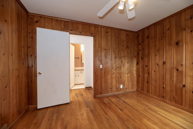 3026 Leigh Ave, Kalamazoo, MI 49048 - empty room featuring wood walls, hardwood / wood-style floors, and ceiling fan