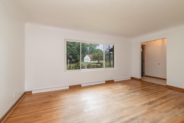 3026 Leigh Ave, Kalamazoo, MI 49048 - empty room featuring a baseboard heating unit and light wood-type flooring