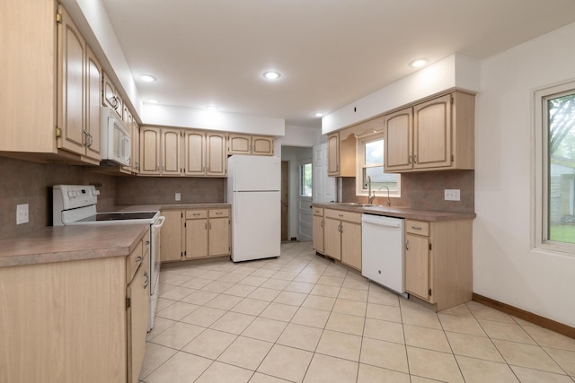 3026 Leigh Ave, Kalamazoo, MI 49048 - kitchen featuring white appliances, decorative backsplash, plenty of natural light, light tile patterned floors, and recessed lighting