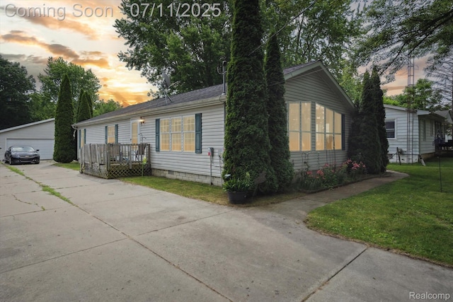 3410 Eastdale Dr, Flint, MI 48506 - view of front of property featuring an outbuilding, a yard, a detached garage, and a deck
