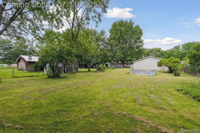 3410 Eastdale Dr, Flint, MI 48506 - view of green lawn with a garage and an outdoor structure