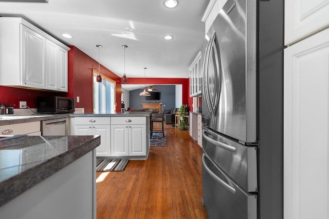 2017 Cumberland Dr, Brighton, MI 48114 - kitchen with stainless steel appliances, white cabinets, ceiling fan, a peninsula, and dark wood-type flooring