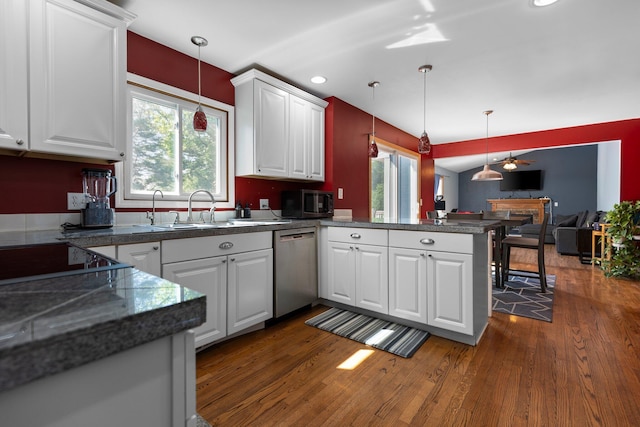 2017 Cumberland Dr, Brighton, MI 48114 - kitchen featuring stainless steel dishwasher, a peninsula, dark wood-type flooring, white cabinetry, and recessed lighting