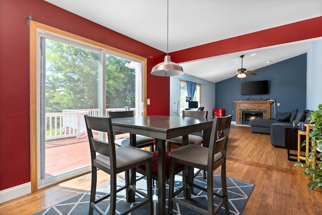 2017 Cumberland Dr, Brighton, MI 48114 - dining area featuring a fireplace, wood finished floors, lofted ceiling, and a ceiling fan