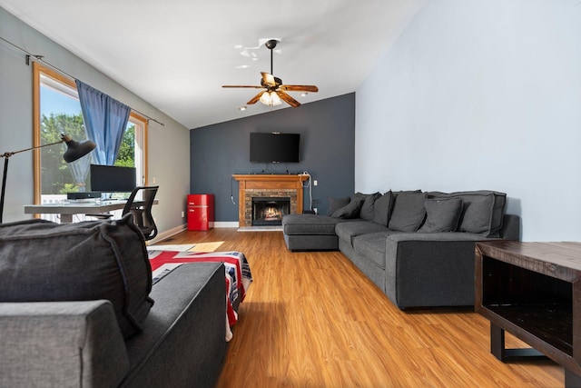 2017 Cumberland Dr, Brighton, MI 48114 - living area with a brick fireplace, light wood-style flooring, vaulted ceiling, and ceiling fan