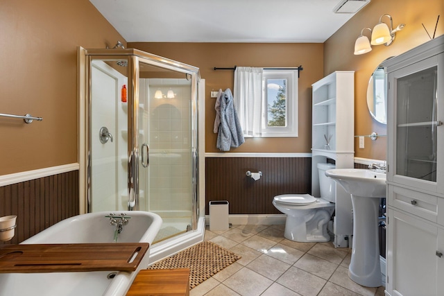 2017 Cumberland Dr, Brighton, MI 48114 - bathroom featuring wainscoting, a soaking tub, a stall shower, and tile patterned floors