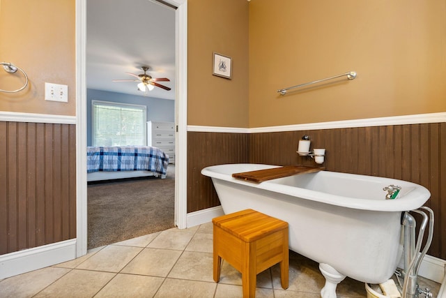 2017 Cumberland Dr, Brighton, MI 48114 - ensuite bathroom featuring a ceiling fan, a freestanding bath, wainscoting, and tile patterned flooring