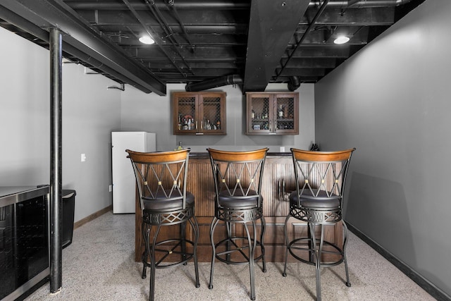 2017 Cumberland Dr, Brighton, MI 48114 - indoor bar featuring freestanding refrigerator and speckled floor