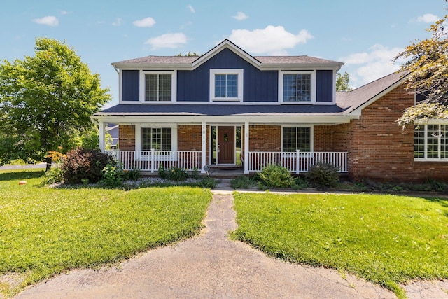 2017 Cumberland Dr, Brighton, MI 48114 - traditional-style house with covered porch, a front lawn, brick siding, and board and batten siding