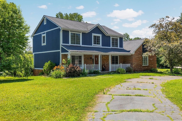 2017 Cumberland Dr, Brighton, MI 48114 - view of front facade with covered porch, a front yard, and brick siding