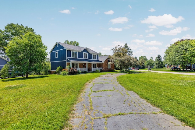 2017 Cumberland Dr, Brighton, MI 48114 - view of front of home featuring a front lawn, asphalt driveway, and brick siding