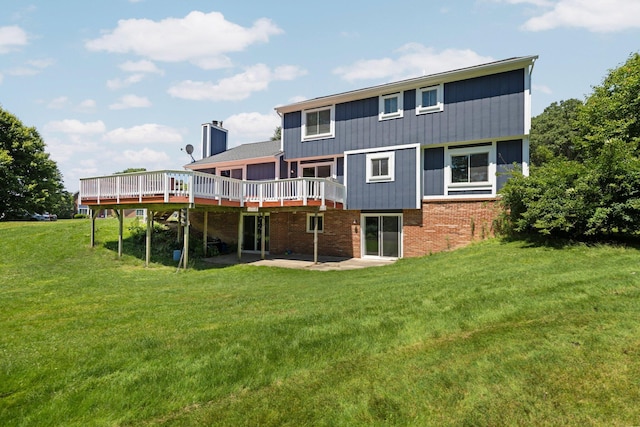 2017 Cumberland Dr, Brighton, MI 48114 - rear view of property with a wooden deck, brick siding, a lawn, and a chimney