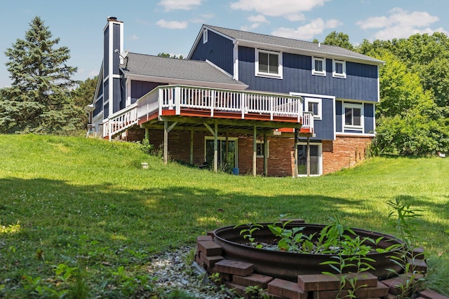 2017 Cumberland Dr, Brighton, MI 48114 - back of house with a deck, a lawn, a chimney, and brick siding