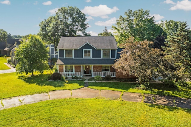 2017 Cumberland Dr, Brighton, MI 48114 - view of front of house featuring covered porch, a front lawn, brick siding, and roof with shingles
