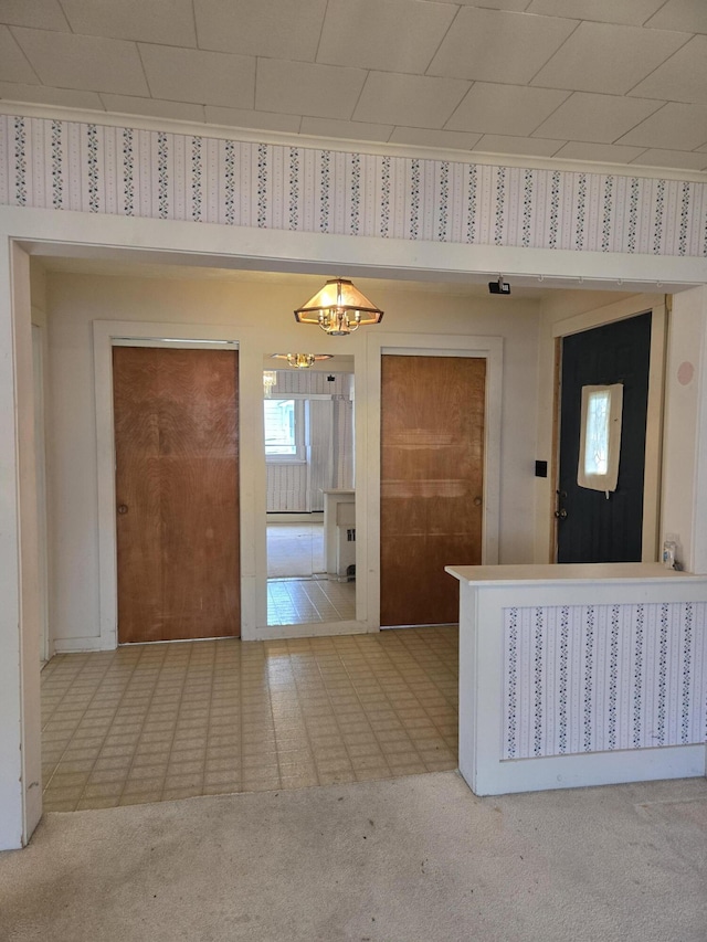 505 N Pine St, Evart, MI 49631 - kitchen featuring carpet flooring, wallpapered walls, and a chandelier