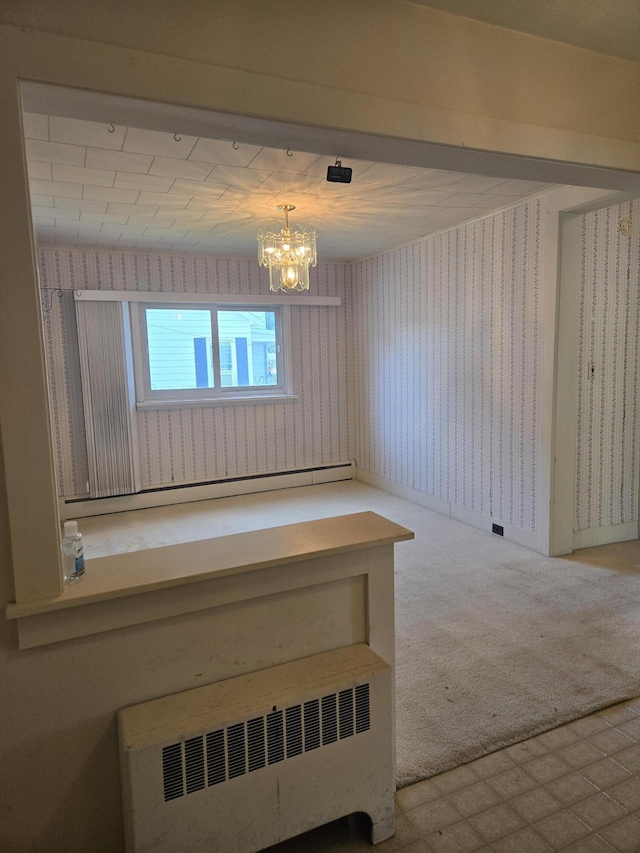 505 N Pine St, Evart, MI 49631 - empty room with wallpapered walls, radiator, a chandelier, tile patterned floors, and a baseboard radiator