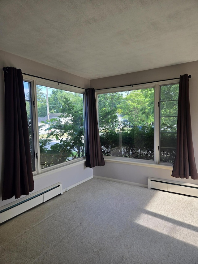 505 N Pine St, Evart, MI 49631 - unfurnished room with a baseboard radiator, carpet floors, and a textured ceiling
