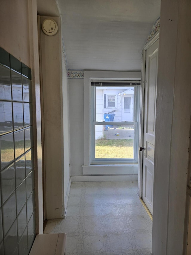 505 N Pine St, Evart, MI 49631 - hallway featuring tile patterned floors and baseboards