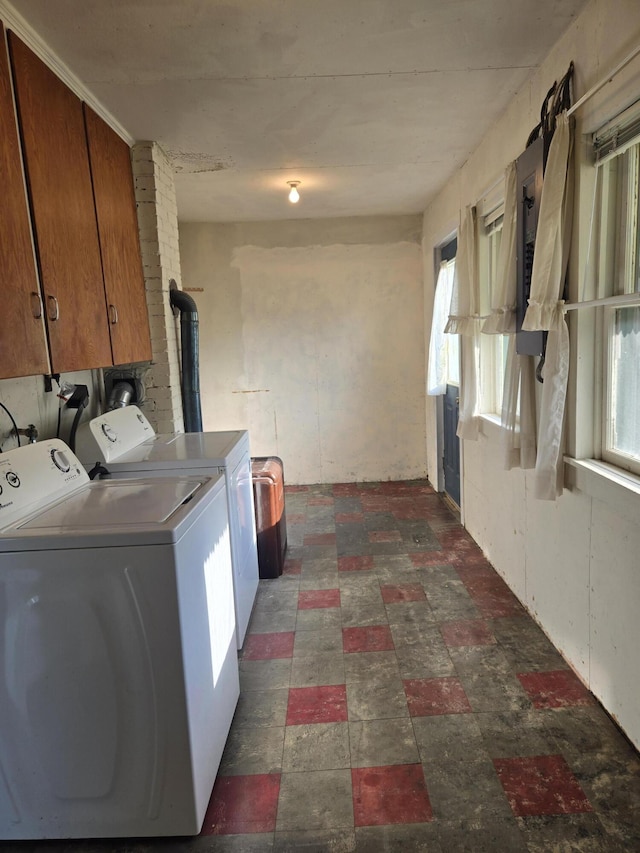 505 N Pine St, Evart, MI 49631 - laundry room with washing machine and clothes dryer, cabinet space, and a wood stove