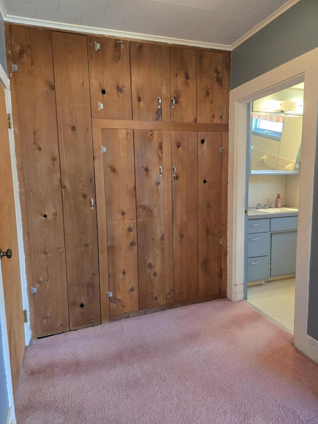 505 N Pine St, Evart, MI 49631 - unfurnished bedroom featuring light carpet, crown molding, and ensuite bathroom