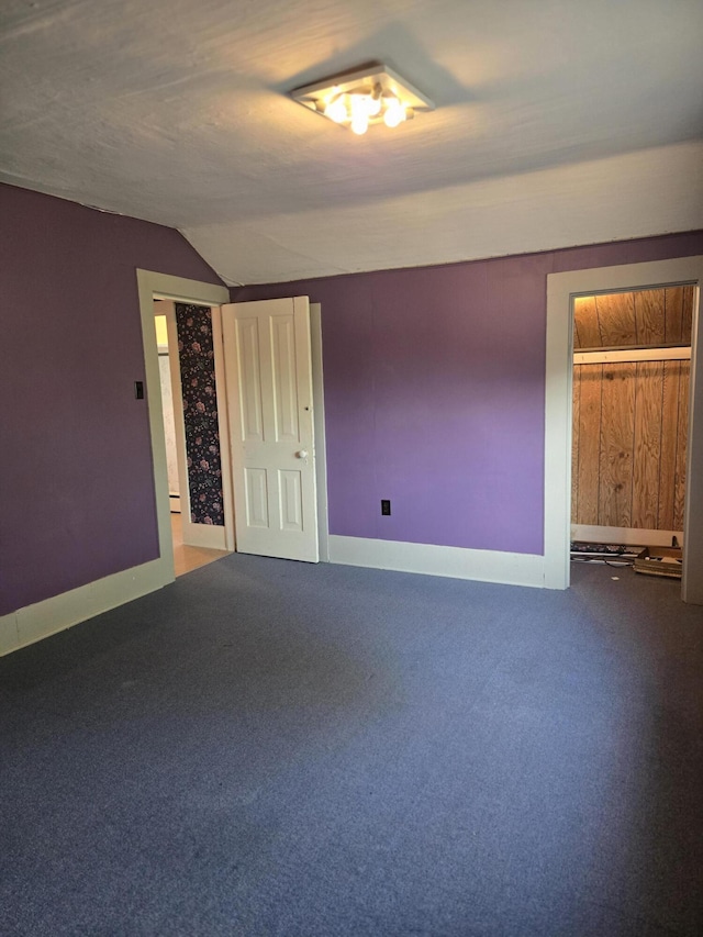 505 N Pine St, Evart, MI 49631 - carpeted empty room featuring lofted ceiling and a baseboard heating unit