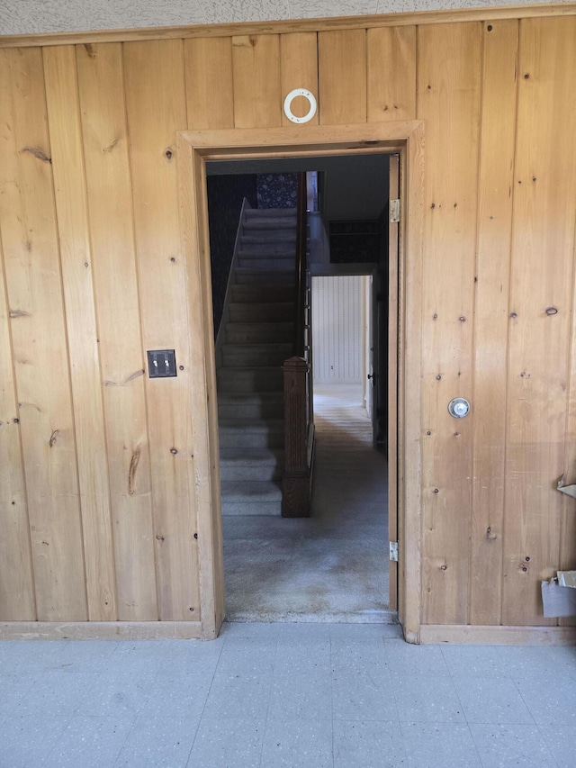 505 N Pine St, Evart, MI 49631 - hallway featuring tile patterned floors and wood walls