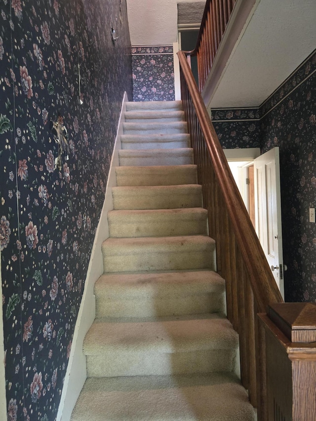 505 N Pine St, Evart, MI 49631 - staircase with wallpapered walls